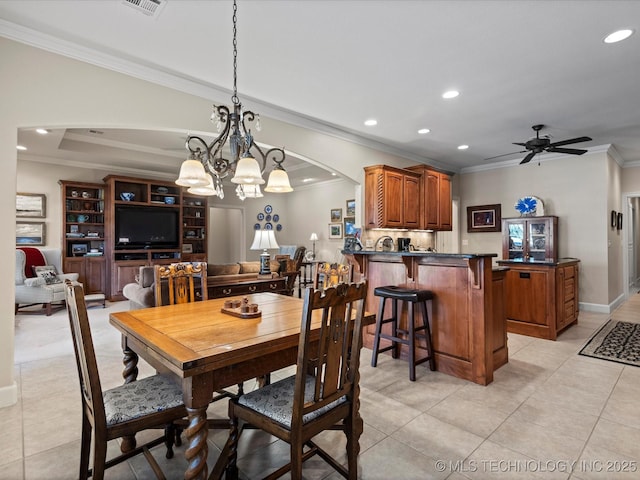 dining space with light tile patterned floors, crown molding, and ceiling fan