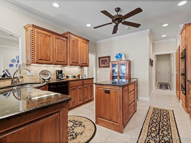 kitchen featuring a kitchen island, tasteful backsplash, black dishwasher, sink, and dark stone counters