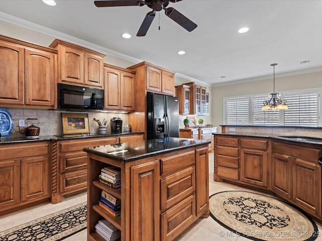 kitchen featuring sink, ornamental molding, a center island, light tile patterned floors, and black appliances