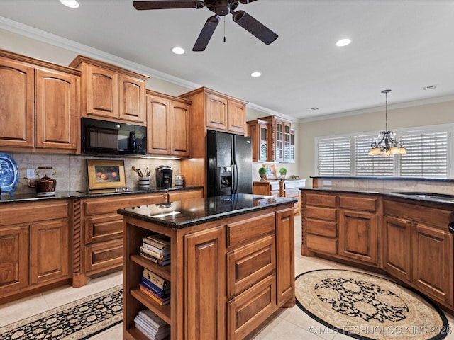 kitchen with a kitchen island, sink, light tile patterned floors, black appliances, and crown molding