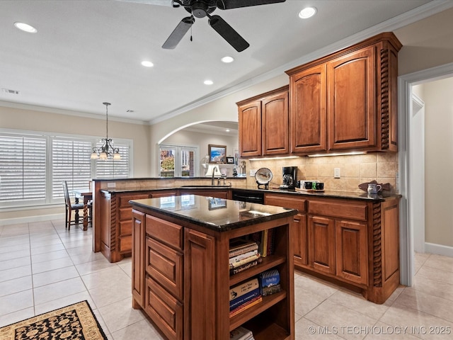 kitchen featuring sink, decorative backsplash, hanging light fixtures, ornamental molding, and kitchen peninsula