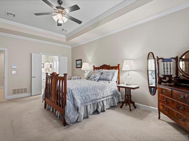 bedroom with ceiling fan, ornamental molding, a tray ceiling, and light carpet