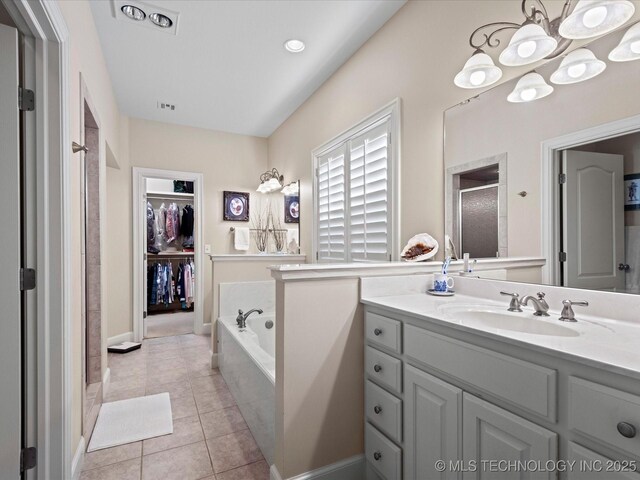 bathroom featuring vanity, separate shower and tub, and tile patterned floors