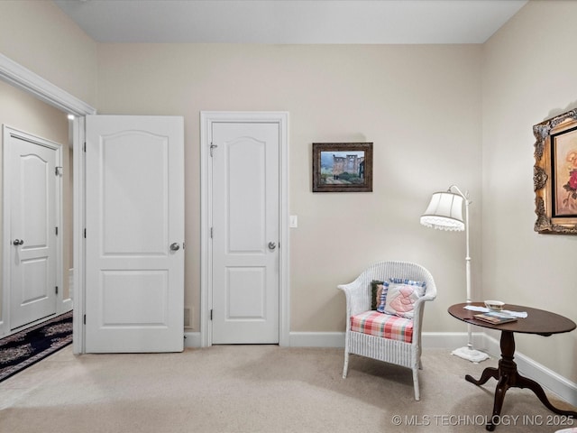 living area featuring light carpet