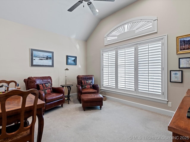 living area featuring ceiling fan, vaulted ceiling, and light carpet