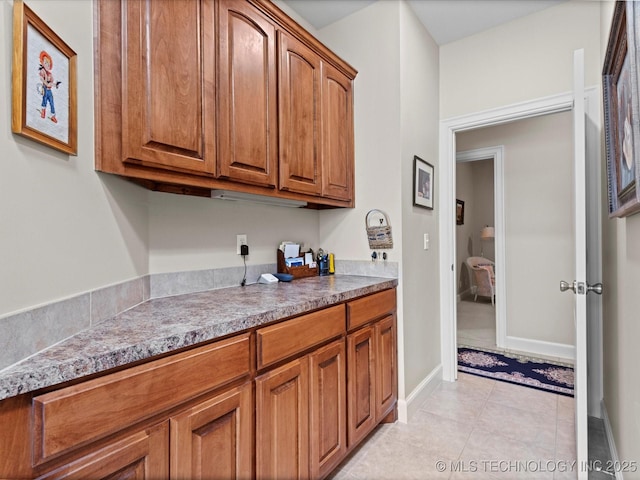 kitchen featuring light stone counters and light tile patterned floors