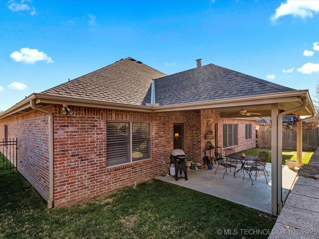 2941 Versailles Pl, Bartlesville, OK 74006 - rear view of house with roof with shingles, brick siding, ceiling fan, and a patio area