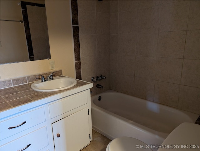 full bathroom with vanity, toilet, and tiled shower / bath combo