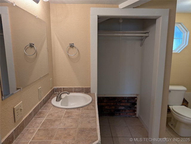 bathroom featuring tile patterned flooring, sink, and toilet