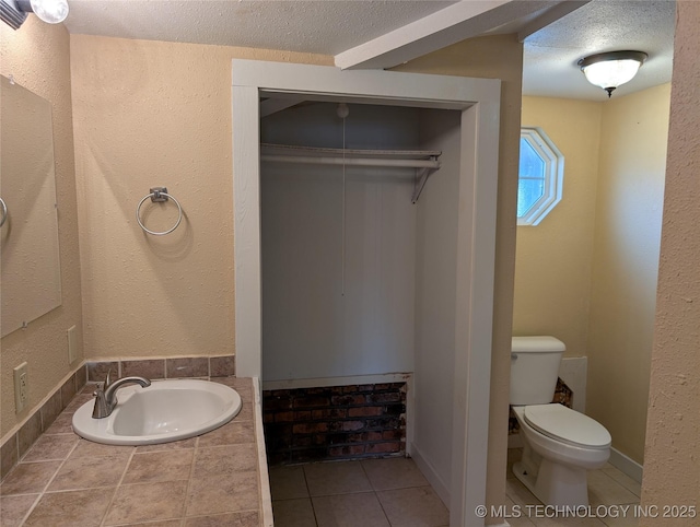 bathroom with toilet, sink, and a textured ceiling