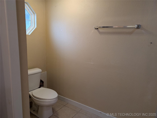 bathroom with tile patterned floors and toilet