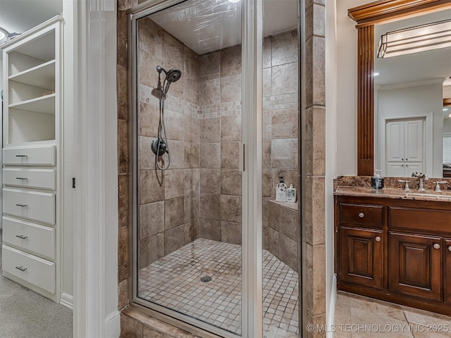 bathroom with vanity and a shower with shower door