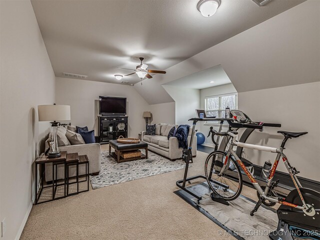 exercise area with lofted ceiling, carpet flooring, and ceiling fan