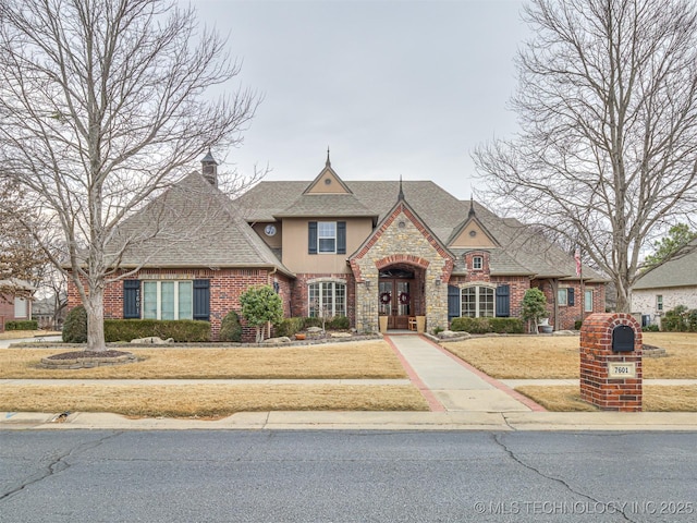 view of front of home featuring a front yard and french doors