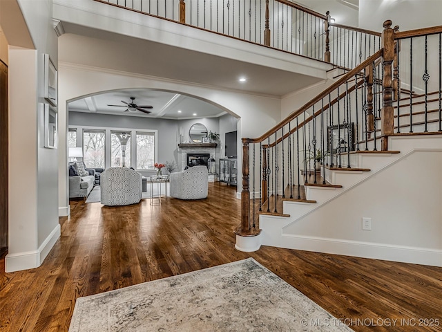 entryway featuring crown molding, wood-type flooring, and ceiling fan