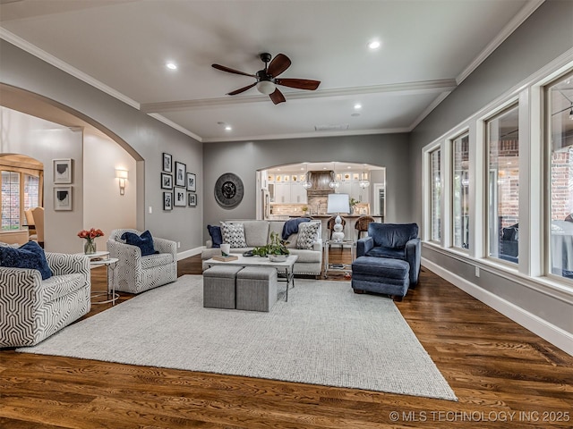 living room with ceiling fan, ornamental molding, and dark hardwood / wood-style floors