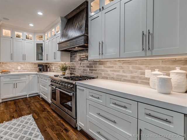 kitchen featuring double oven range, premium range hood, and white cabinets