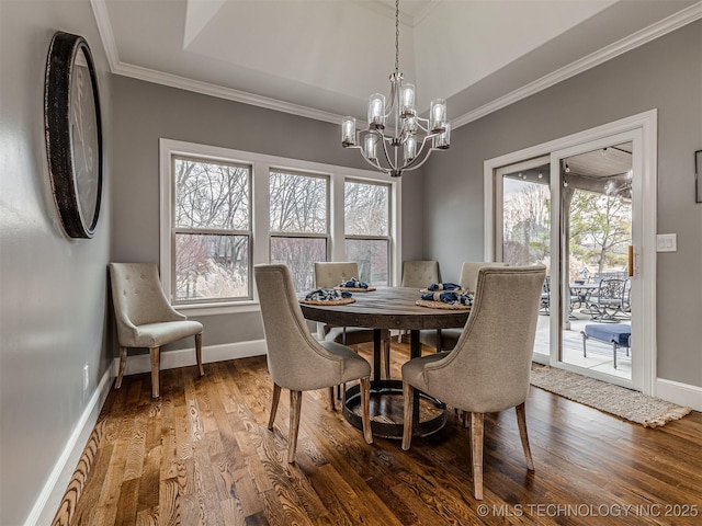 dining room featuring hardwood / wood-style floors, crown molding, and a wealth of natural light