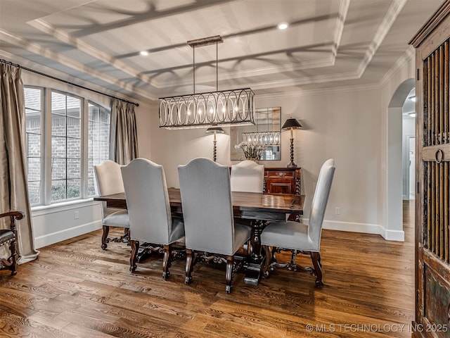 dining room featuring hardwood / wood-style flooring, ornamental molding, and a tray ceiling