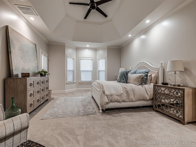 carpeted bedroom with crown molding, ceiling fan, and a tray ceiling