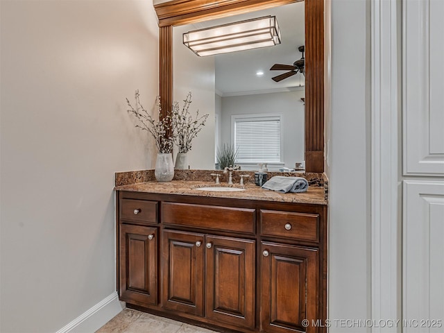 bathroom featuring crown molding, ceiling fan, and vanity