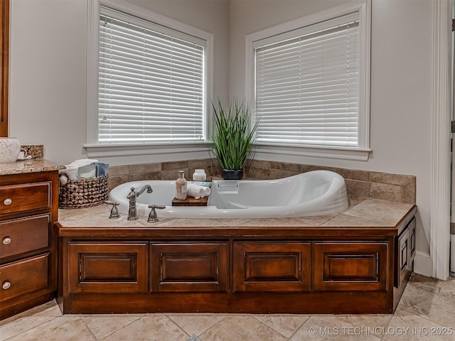 bathroom with a tub to relax in and vanity