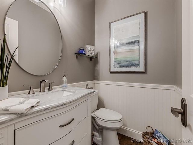 bathroom featuring vanity, hardwood / wood-style floors, and toilet