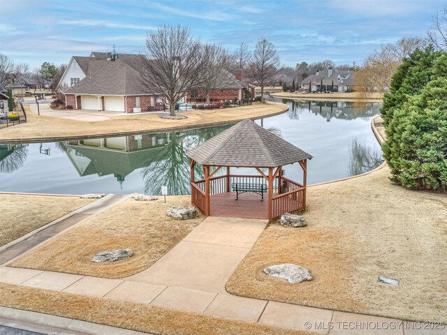 view of swimming pool featuring a gazebo and a water view