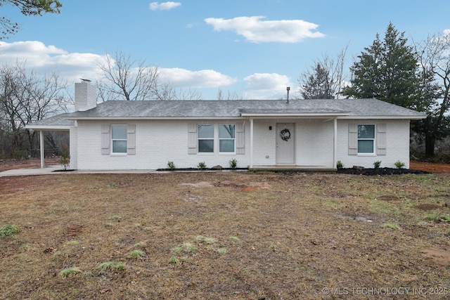 ranch-style home featuring a front yard and a carport