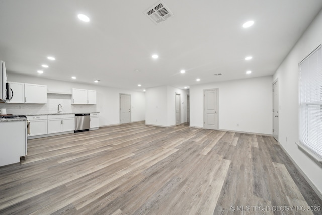 unfurnished living room with sink and light wood-type flooring