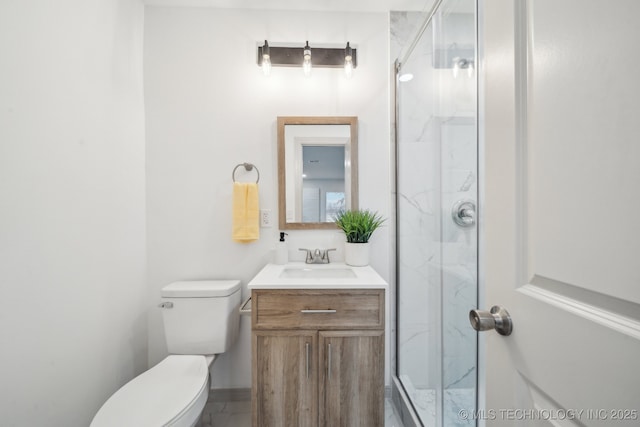 bathroom featuring vanity, toilet, and an enclosed shower