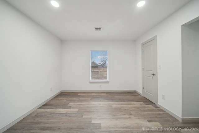 spare room featuring light wood-type flooring