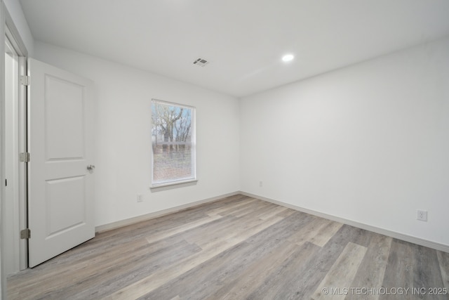 spare room featuring light hardwood / wood-style floors