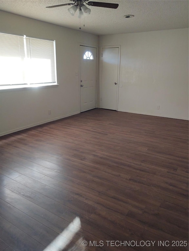 foyer entrance featuring ceiling fan, dark hardwood / wood-style floors, and a textured ceiling