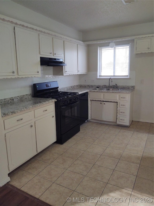 kitchen with sink, white cabinetry, a textured ceiling, light tile patterned floors, and black appliances