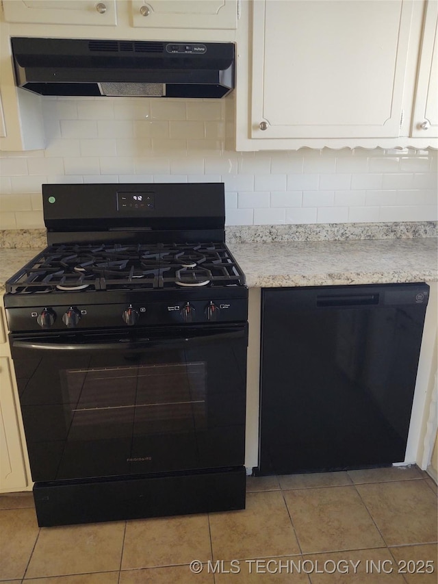 kitchen featuring white cabinetry, light tile patterned floors, backsplash, and black appliances