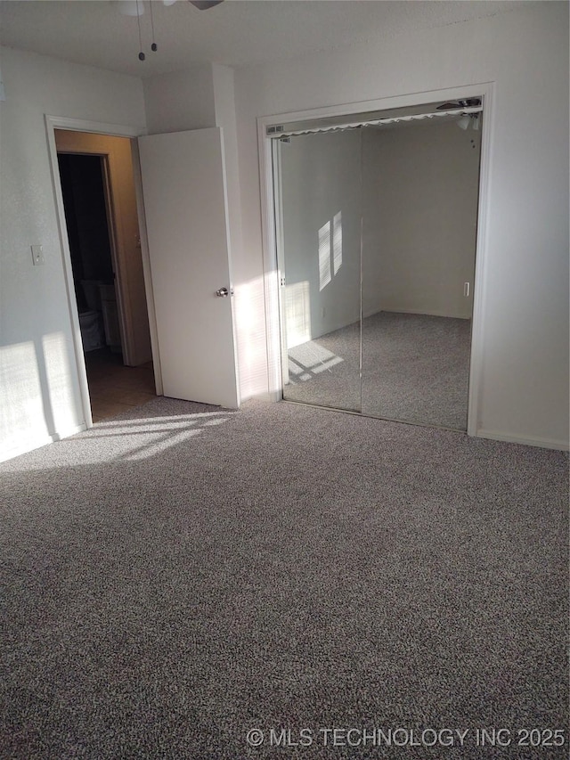 unfurnished bedroom featuring a closet and carpet flooring