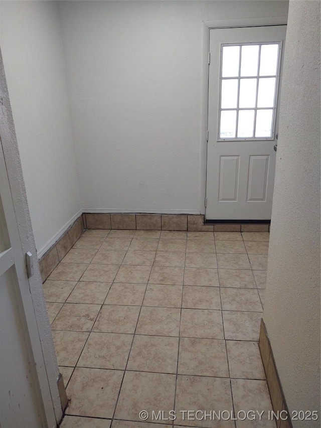 empty room with light tile patterned floors