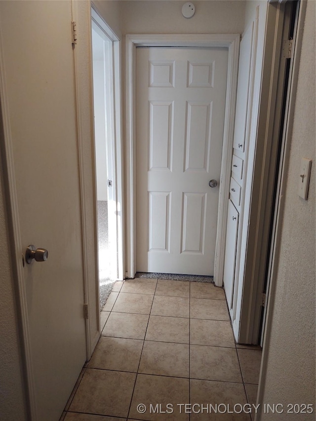 hall with light tile patterned floors