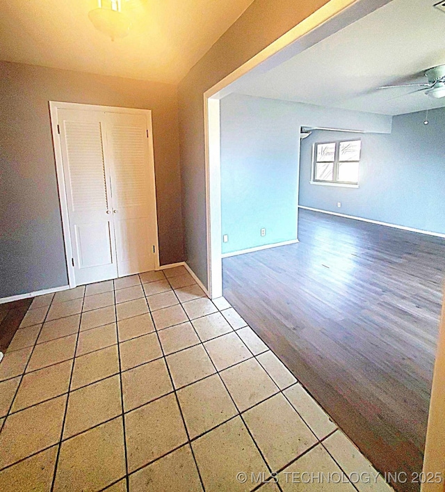 empty room featuring tile patterned floors and ceiling fan