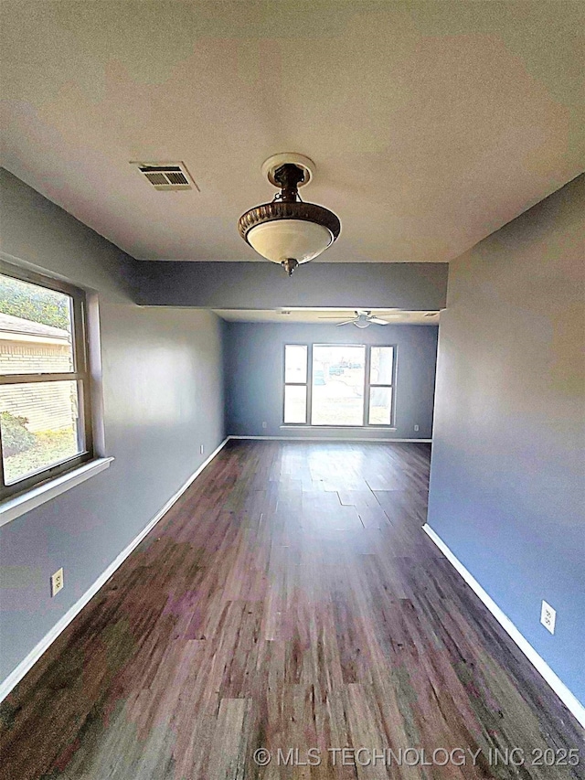 empty room with dark wood-type flooring