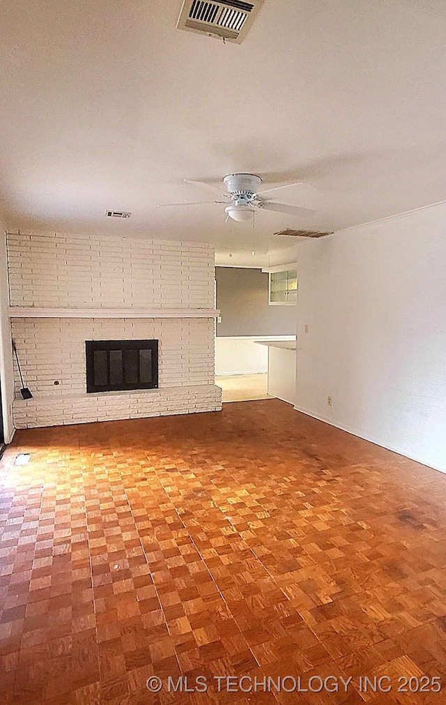 unfurnished living room with a brick fireplace and ceiling fan