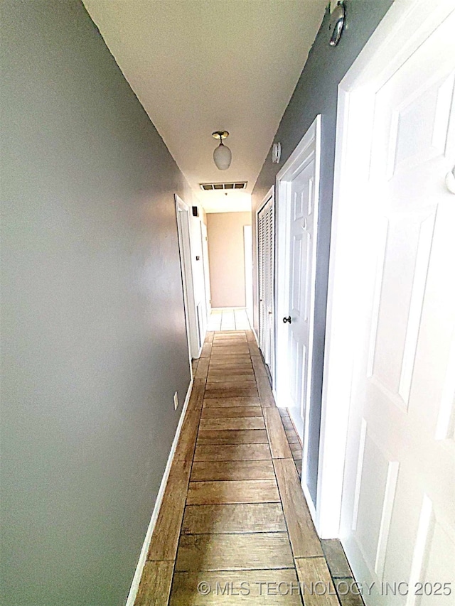 corridor with light hardwood / wood-style flooring