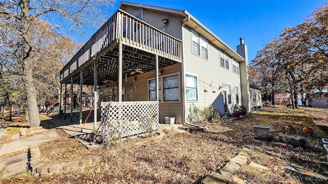 116568 S 4268th Rd, Checotah, OK 74426 - view of side of property with a deck, a chimney, a ceiling fan, and a patio