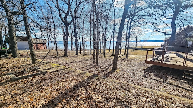 view of yard featuring a deck with water view