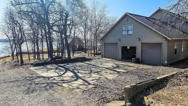 116568 S 4268th Rd, Checotah, OK 74426 - view of side of property with driveway, roof with shingles, and a garage