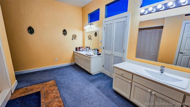 116568 S 4268th Rd, Checotah, OK 74426 - bathroom with two vanities, baseboards, and a closet