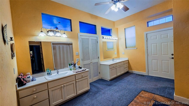 116568 S 4268th Rd, Checotah, OK 74426 - full bath with a textured wall, a ceiling fan, two vanities, tile patterned flooring, and baseboards