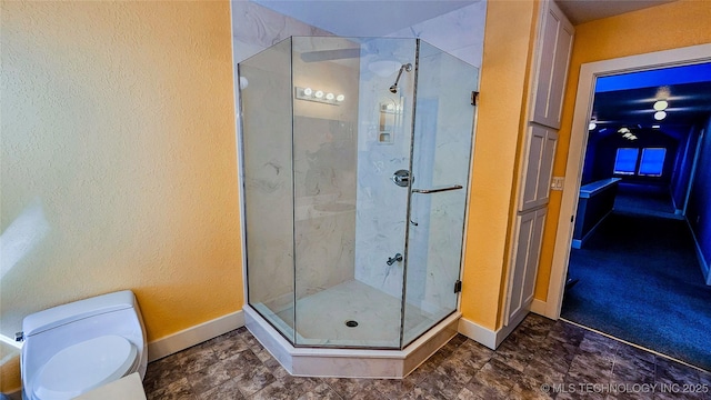 116568 S 4268th Rd, Checotah, OK 74426 - full bathroom featuring a stall shower, baseboards, toilet, and a textured wall