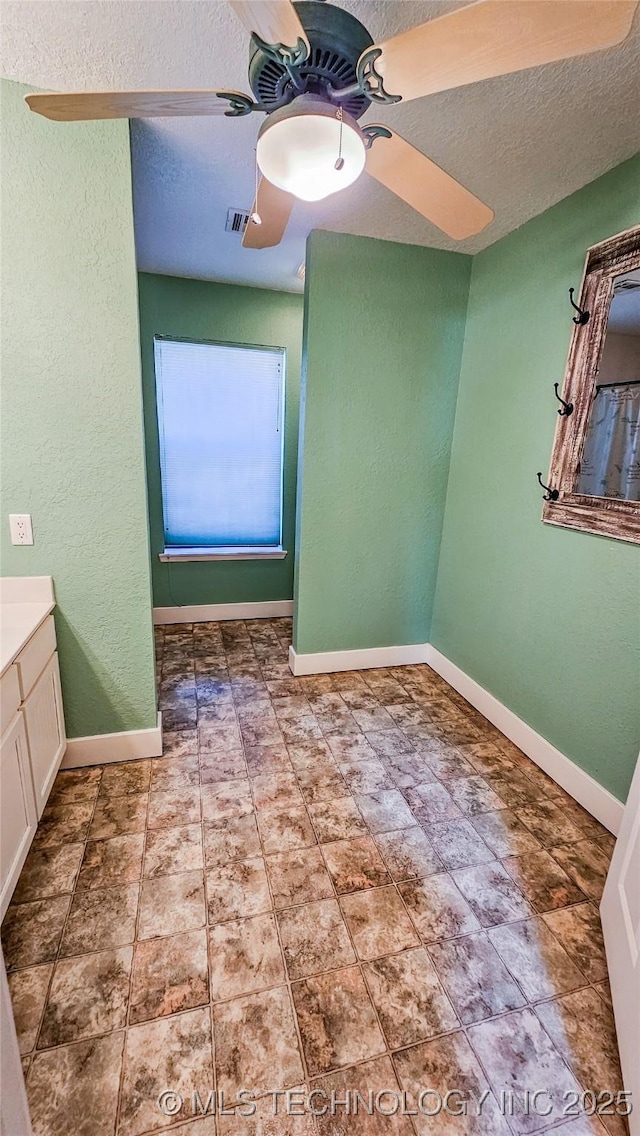 bathroom with vanity, a textured ceiling, and ceiling fan